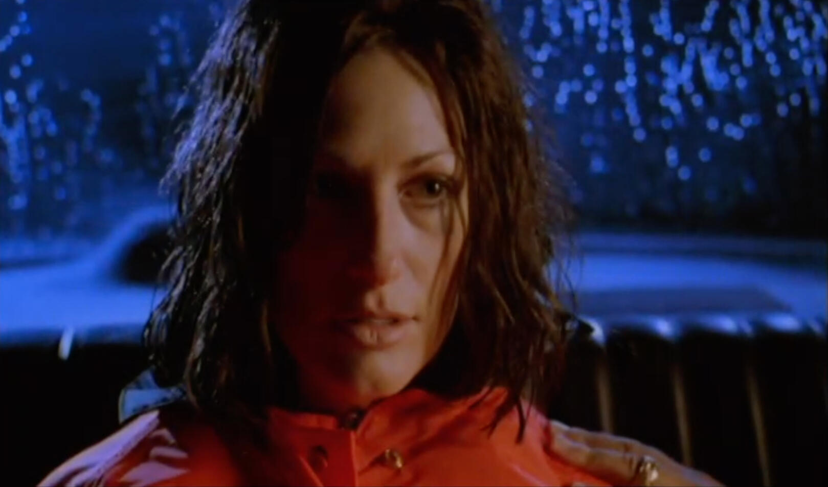 Harsh sidelight car interior and woman's face at night in the rain
