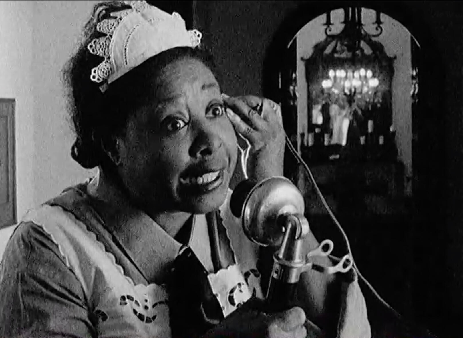 Return to Babylon woman on vintage phone, shot with hand crank camera from 1920's silent period film